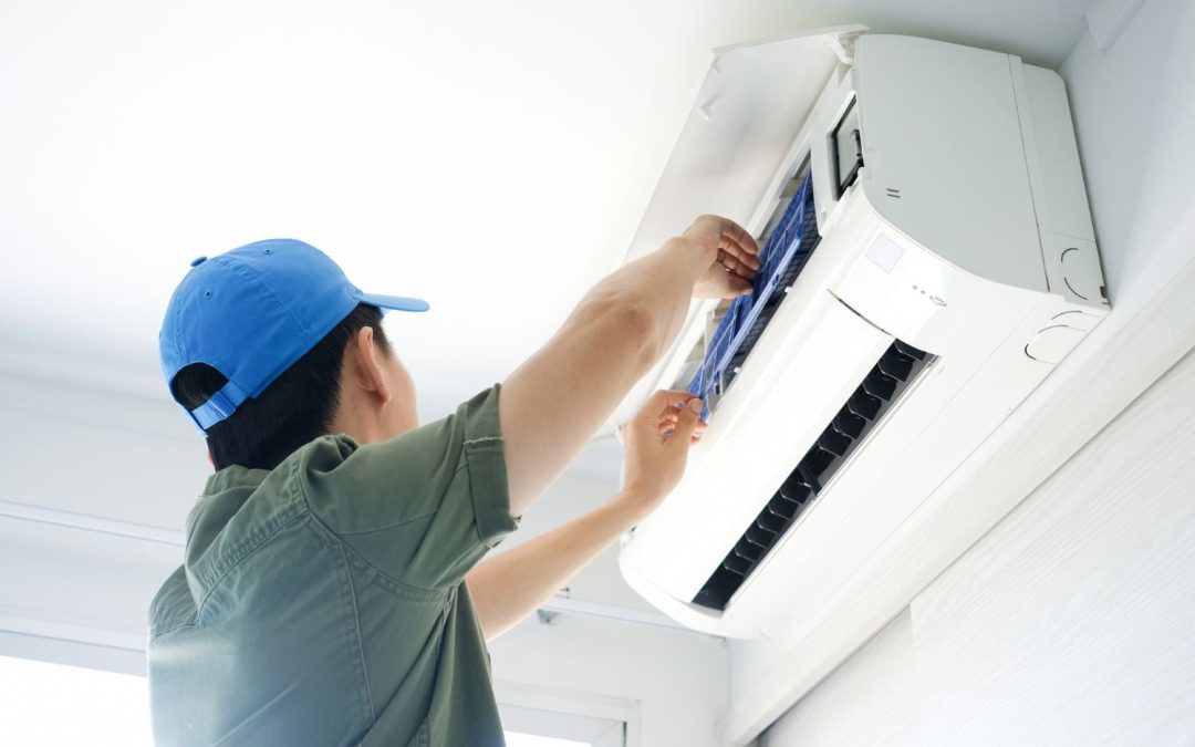 Air conditioning technician maintaining an indoor mini split system in Johnstown, CO