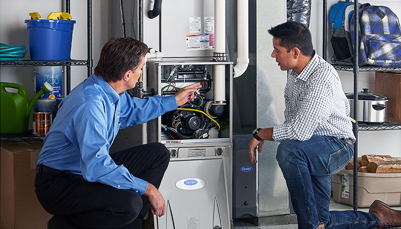 HVAC technician evaluating a furnace for repair or replacement in Johnstown