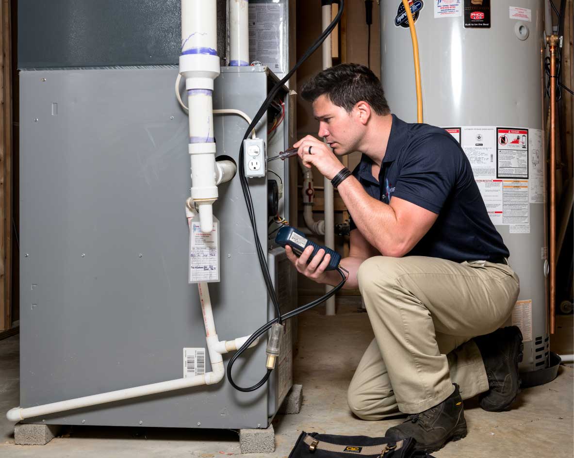 HVAC technician performing a furnace tune-up in Johnstown