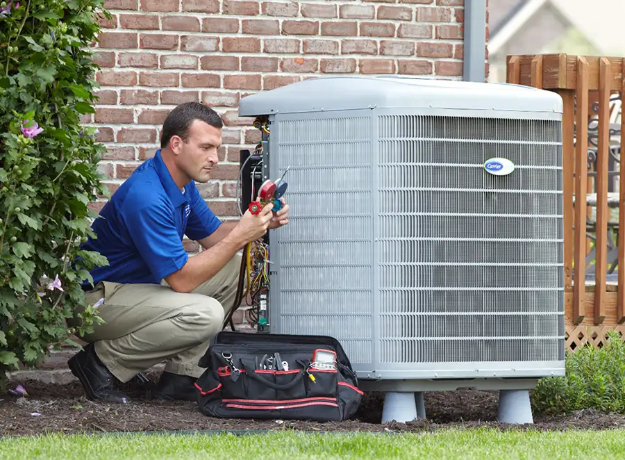 HVAC technician inspecting an outdoor air conditioning unit in Johnstown