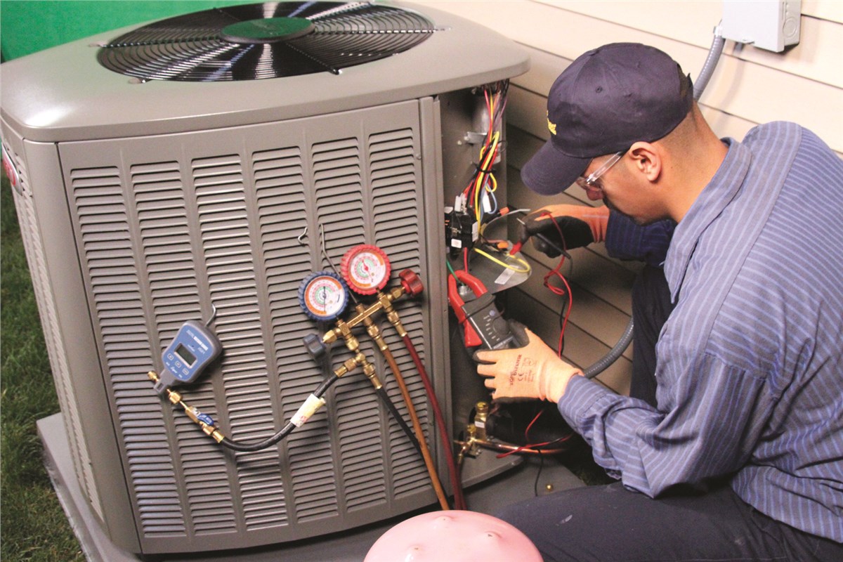 HVAC technician testing an outdoor air conditioning unit in Johnstown